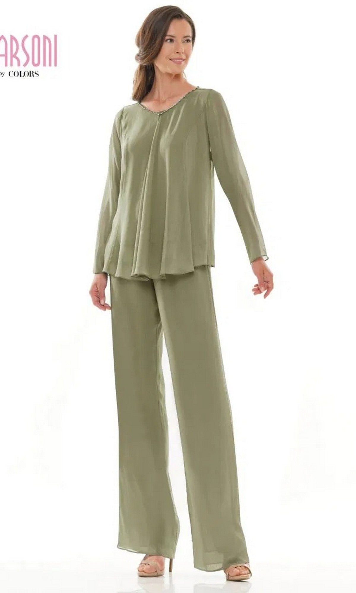 A woman stands against a white background wearing the Marsoni M304 long formal pantsuit in sage, featuring a loose-fitting, long-sleeved top with matching wide-leg pants and beige heels.